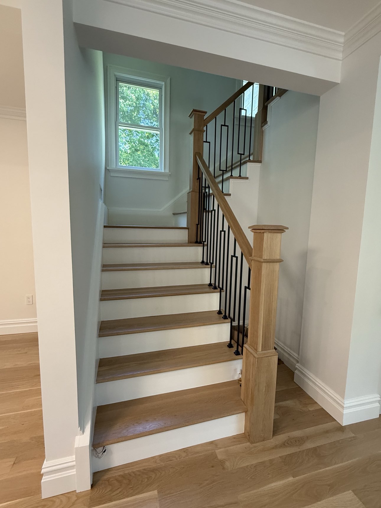 Completed staircase with wood railing